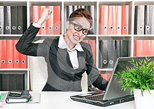 Angry business woman wants to break computer