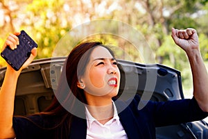The angry business woman was angry at the breakdown of the car