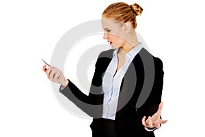 Angry business woman yelling to the mobile phone