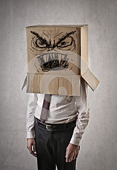 Angry businessman with a box on his head