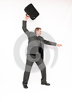 Angry businessman ejecting briefcase.