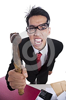 Angry businessman hitting with hammer