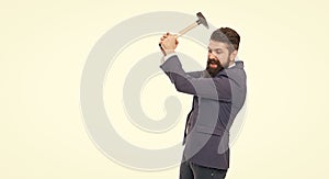 Angry businessman holding hammer isolated on white. Professional man got angry. Anger management