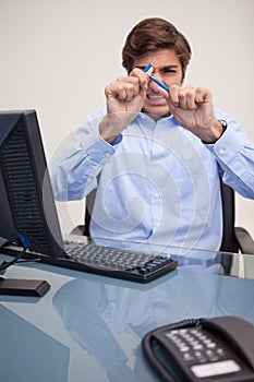 Angry businessman just broke his pencil