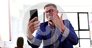 Angry businessman manager swearing at mobile phone screen over video call 4k movie