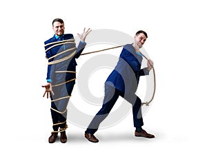 Angry businessman pulls tied himself with a rope.
