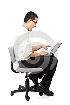 Angry businessman screaming against a laptop