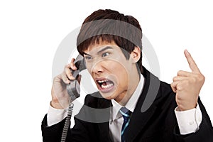 Angry businessman screaming on the phone