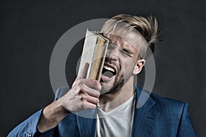 Angry businessman shout with book, knowledge