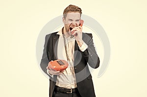 Angry businessman shout in vintage phone receiver holding landline telephone, telephony