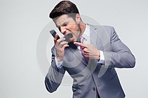 Angry businessman shouting on the phone
