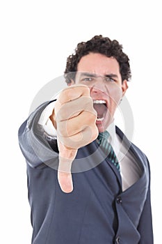 Angry businessman showing thumb down gesture as rejection symbol