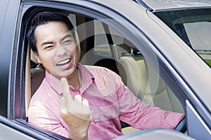 Angry businessman shows middle finger