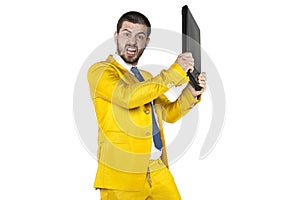 Angry businessman smashing computer