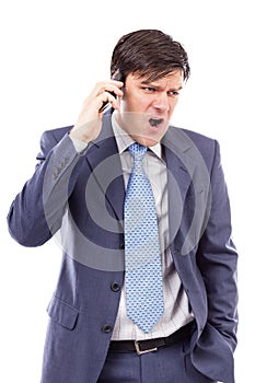 Angry businessman speaking on mobile phone and shouting