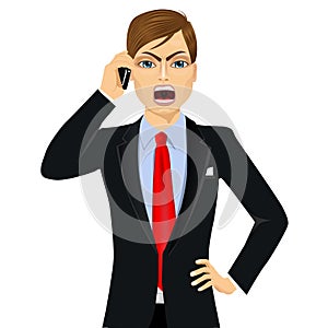 Angry businessman talking on mobile phone