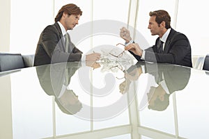 Angry Businessmen At Conference Table