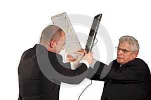 Angry businessmen fighting with keyboards