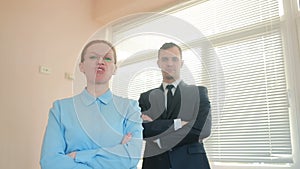 Angry businessmen, man and woman in the office, screaming at the camera close-up