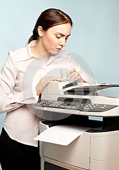 Angry businesswoman with copier and cup of coffee