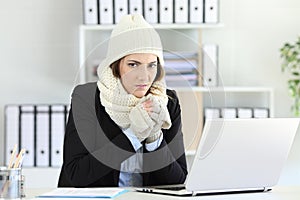 Angry businesswoman having cold at office