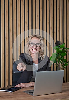 Angry businesswoman pointing out in the office