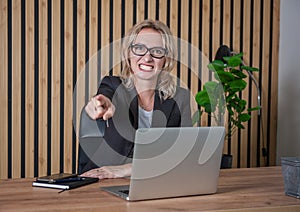 Angry businesswoman pointing out in the office