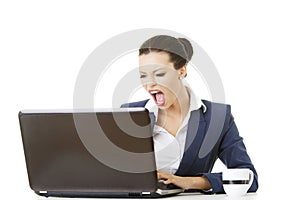 Angry businesswoman shouting on her laptop