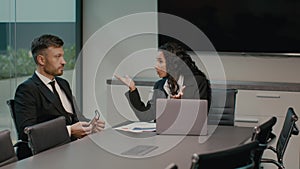 Angry Businesswoman Shouting At Male Employee At Workplace Indoor