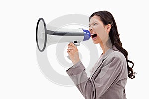 Angry businesswoman shouting through megaphone