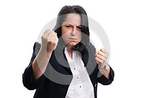 Angry businesswoman showing fists as aggressive concept