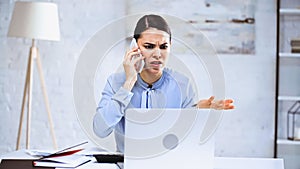 angry businesswoman talking on smartphone while