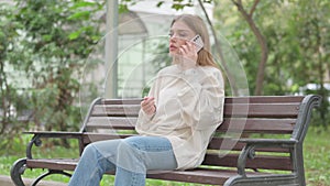 Angry Casual Young Woman Talking on phone Outdoor