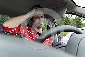 Angry caucasian man into car in spring time. Stressed and bored man into vehicle concept. Man blocked into traffic