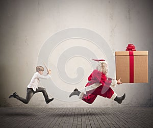 Angry child chasing Santa Claus