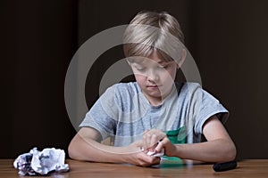 Angry child destroying his drawing photo