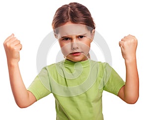 Angry child evil girl shows fists experiencing