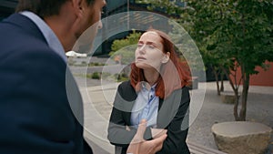 Angry colleagues argue business man and woman shouting outdoors in city aggressive businessman and Caucasian