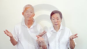 Angry complain Asian elderly couple with upset expression and ge