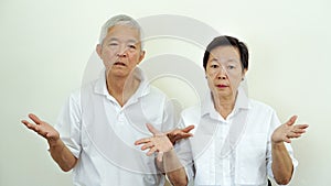 Angry complain Asian elderly couple with upset expression and ge