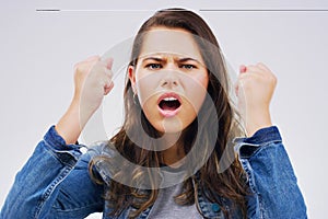 Angry, conflict and frustration with portrait of woman in studio isolated on gray background. Face, fail or fist and