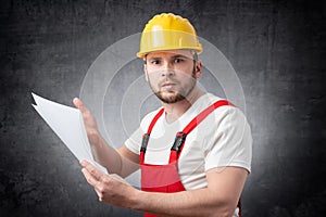 Angry construction worker holding papers