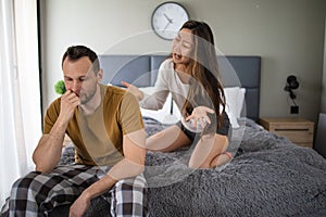 Angry couple in bedroom. Young couple having an argument in the bedroom
