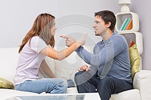 Angry couple having an argument in their living room