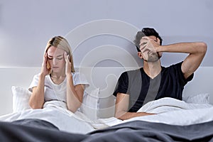 Angry couple having arguments and sexual problems in bed. Portrait of unhappy couple