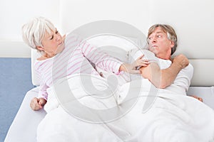 Angry Couple Lying On Bed