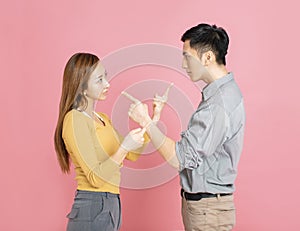 Angry couple pointing at each other while arguing