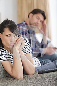 angry couple sitting apart on coach irritated after quarrel misunderstanding