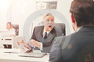 Angry disappointed executive shouting at the employee