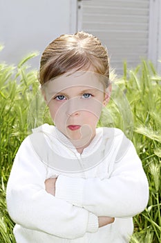 Angry disappointed gesture little girl meadow